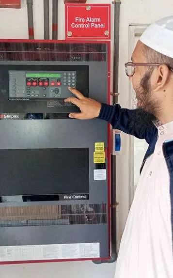 Fire alarm control panel being checked