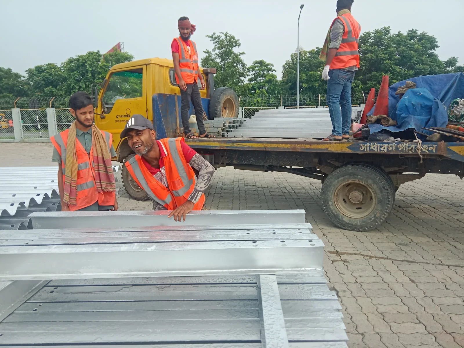 FTSL project crew handling guardrail components at the Padma Road site