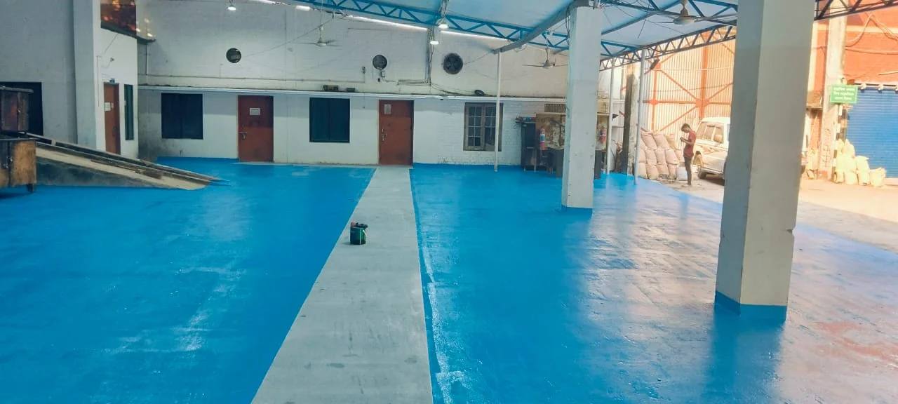 Blue and grey floor coating inside a facility — RHD - Epoxy Painting
