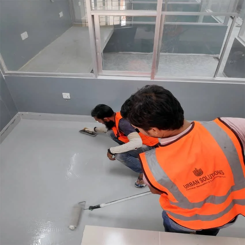 Worker applying a floor finish